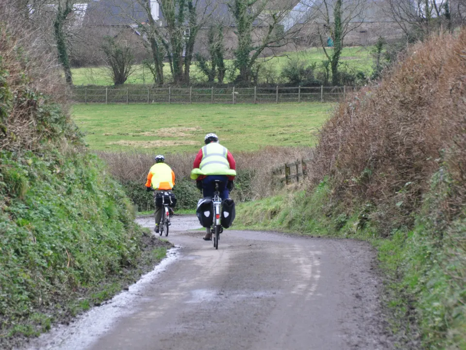Cyclists riding along a quiet countryside road in Mid Devon